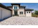 Beautiful contemporary facade featuring a wide driveway and inviting entryway to the home at 5061 Collingswood Blvd, Port Charlotte, FL 33948