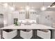 Spacious kitchen with island featuring barstool seating and pendant lighting at 5061 Collingswood Blvd, Port Charlotte, FL 33948