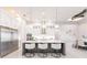 Bright kitchen with an oversized island with pendant lighting, modern stainless appliances, and large cabinetry at 5061 Collingswood Blvd, Port Charlotte, FL 33948