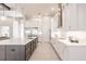 Bright kitchen featuring a large island with marble counters, stainless appliances, and custom cabinetry at 5061 Collingswood Blvd, Port Charlotte, FL 33948