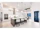 Gourmet kitchen with an oversized island, custom pendant lighting, stainless appliances, and views to the dining area at 5061 Collingswood Blvd, Port Charlotte, FL 33948
