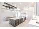 Bright kitchen with a marble island, stainless appliances, custom cabinets and fixtures, and an open floor plan at 5061 Collingswood Blvd, Port Charlotte, FL 33948