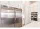 Kitchen has stainless refrigerator, double ovens and plentiful white cabinets at 5061 Collingswood Blvd, Port Charlotte, FL 33948