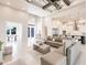 Bright living room featuring high ceilings, fan, and views to the gourmet kitchen with modern appliances and custom lighting at 5061 Collingswood Blvd, Port Charlotte, FL 33948