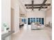 Open-concept living room with high ceilings, ceiling fans, and access to outdoor views at 5061 Collingswood Blvd, Port Charlotte, FL 33948