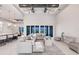 Bright living room featuring high ceilings, fan, and large sliding glass doors with views to outdoor living at 5061 Collingswood Blvd, Port Charlotte, FL 33948