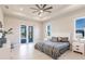 Main bedroom with a ceiling fan, sliding doors to the lanai, and two windows at 5061 Collingswood Blvd, Port Charlotte, FL 33948