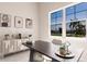 Office with a view of the neighborhood through large windows, desk, and sideboard at 5061 Collingswood Blvd, Port Charlotte, FL 33948