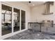 Covered patio features a stainless steel outdoor kitchen and a water view beyond sliding glass doors at 5061 Collingswood Blvd, Port Charlotte, FL 33948