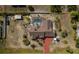 This bird's eye view shows a home with a pool, well-maintained landscaping, and a long driveway at 5219 Guava Ter, Port Charlotte, FL 33981