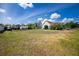 Expansive backyard featuring a shed, lush greenery, a screened-in pool, and ample space at 5219 Guava Ter, Port Charlotte, FL 33981