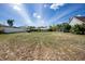 Spacious backyard offering ample space, featuring a shed, lush greenery, and a screened-in pool area at 5219 Guava Ter, Port Charlotte, FL 33981