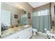 Full bathroom with vanity, shower curtain, and granite countertops at 5219 Guava Ter, Port Charlotte, FL 33981