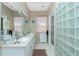 Bright bathroom featuring a dual vanity, and a glass block shower at 5219 Guava Ter, Port Charlotte, FL 33981
