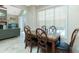 Dining room with decorative chairs, natural lighting, and view into a connecting living room area at 5219 Guava Ter, Port Charlotte, FL 33981