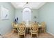 Dining room features tray ceiling, large window, and wooden chairs surrounding an oval-shaped dining table at 5219 Guava Ter, Port Charlotte, FL 33981