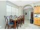 Dining room features a stone-topped table, seating for six, and abundant natural light from a large window at 5219 Guava Ter, Port Charlotte, FL 33981
