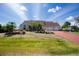 Charming single-story home with a three-car garage, well-maintained landscaping, and a red brick driveway at 5219 Guava Ter, Port Charlotte, FL 33981