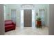 Inviting foyer with a neutral color scheme, tiled floors, and a solid wood front door with sidelights at 5219 Guava Ter, Port Charlotte, FL 33981