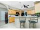 Kitchen showcasing wood cabinetry, granite countertops, a breakfast bar with seating, and modern appliances at 5219 Guava Ter, Port Charlotte, FL 33981