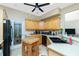Well-equipped kitchen features wood cabinets, island, black appliances and views to the outdoor area at 5219 Guava Ter, Port Charlotte, FL 33981