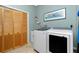 Laundry room features a new washer and dryer set and cabinets at 5219 Guava Ter, Port Charlotte, FL 33981