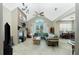 Spacious living room with high ceilings, a fireplace, neutral walls, and tile flooring throughout at 5219 Guava Ter, Port Charlotte, FL 33981