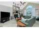 Cozy living room featuring a fireplace, a comfortable green sofa, and access to the lanai at 5219 Guava Ter, Port Charlotte, FL 33981