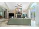 Bright living room featuring a fireplace, a comfortable green sofa, and access to the lanai at 5219 Guava Ter, Port Charlotte, FL 33981