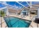 Beautiful screened-in pool area featuring lounge chairs, dining set, and ample space for relaxation at 5219 Guava Ter, Port Charlotte, FL 33981