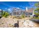 Exterior view of a house with a screened-in pool and landscaped yard, offering a private outdoor oasis at 5219 Guava Ter, Port Charlotte, FL 33981