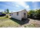 Exterior of a storage shed with a double door, single door and security screen with yard on a sunny day at 5219 Guava Ter, Port Charlotte, FL 33981