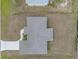 An aerial view of a home featuring a geometric roofline and a well-manicured lawn at 5353 Kaspar St, Port Charlotte, FL 33981
