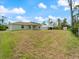 A spacious backyard featuring green grass, trees and a shed, ideal for outdoor activities and relaxation at 5353 Kaspar St, Port Charlotte, FL 33981