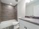 Bathroom featuring tiled shower and tub with elegant vanity at 5353 Kaspar St, Port Charlotte, FL 33981