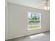 Bright bedroom features a ceiling fan, window, and tile floors at 5353 Kaspar St, Port Charlotte, FL 33981
