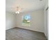 Bright bedroom offers a ceiling fan, window, and tile floors at 5353 Kaspar St, Port Charlotte, FL 33981