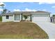 Charming single-story home featuring a two-car garage and well-manicured front yard at 5353 Kaspar St, Port Charlotte, FL 33981