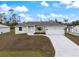 An inviting single-story home featuring a well-kept lawn, a driveway, and a convenient two-car garage at 5353 Kaspar St, Port Charlotte, FL 33981