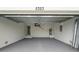Spacious two-car garage with high ceilings, painted floor, and convenient access to the house at 5353 Kaspar St, Port Charlotte, FL 33981