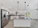 Modern kitchen boasts stainless steel appliances, white cabinetry, and a spacious center island at 5353 Kaspar St, Port Charlotte, FL 33981