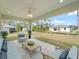 Relax on the covered patio with plenty of seating and view of the backyard at 5353 Kaspar St, Port Charlotte, FL 33981