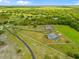 Expansive property with long driveway and a screened-in pool, offering privacy and curb appeal at 5600 Blackjack S Ct, Punta Gorda, FL 33982