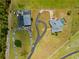 Aerial view of the property and home showing the circular driveway, detached garage and screened pool at 5600 Blackjack S Ct, Punta Gorda, FL 33982