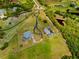 An aerial view showcases the property with a circular driveway, detached garage and inviting pool and lanai at 5600 Blackjack S Ct, Punta Gorda, FL 33982