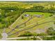 Aerial view of the large property with pond, accessory garage, home and white outlined property lines at 5600 Blackjack S Ct, Punta Gorda, FL 33982