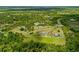 Expansive aerial view of the property, surrounded by lush trees and neighboring homes at 5600 Blackjack S Ct, Punta Gorda, FL 33982