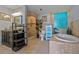 Luxurious bathroom with a stand-alone tub, walk-in shower, and tiled floor at 5600 Blackjack S Ct, Punta Gorda, FL 33982