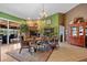 Beautiful dining area with green walls, stone fireplace, and seamless access to the outdoor space at 5600 Blackjack S Ct, Punta Gorda, FL 33982
