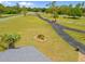 Aerial view of the long black driveway leading to the main house with landscaping in the circular median at 5600 Blackjack S Ct, Punta Gorda, FL 33982